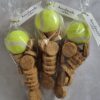 hree clear cellophane bags, each containing a bright yellow tennis ball and a pile of small, round dog treats, with 'handmade with love' tags.