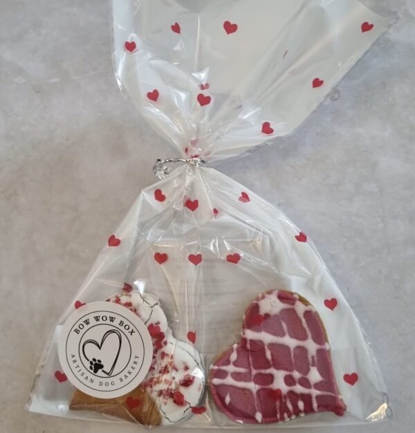 Love Bites Valentine Dog Treats Gift Bag | Bow Wow Box UK Valentine dog treats UK Love Bites gift bag with heart-shaped cookies in cellophane with red hearts from Bow Wow Box Artisan Dog Bakery
