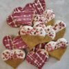 Love Bites Valentine Dog Treat Collection | Handmade in UK Collection of Love Bites Valentine dog treats UK showing variety of heart-shaped cookies with pink icing and sprinkles